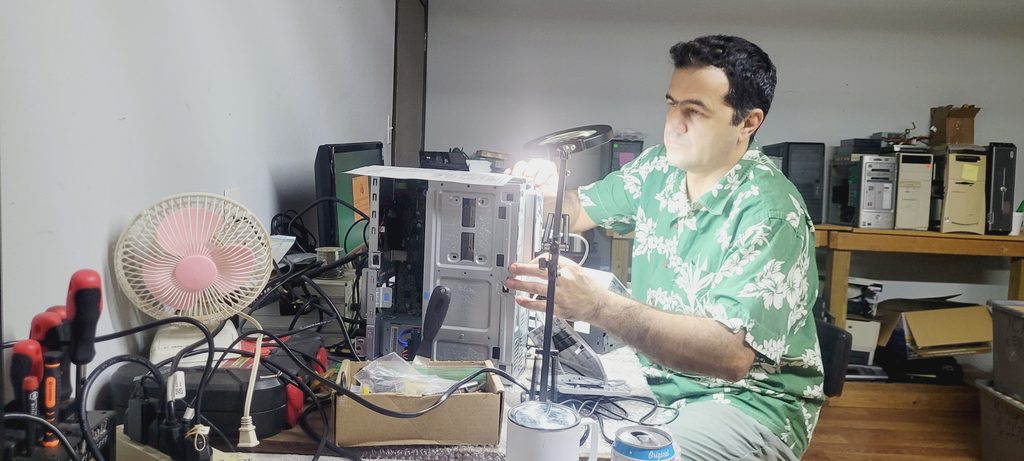 Technician performing data recovery on a computer for a client in Houston.