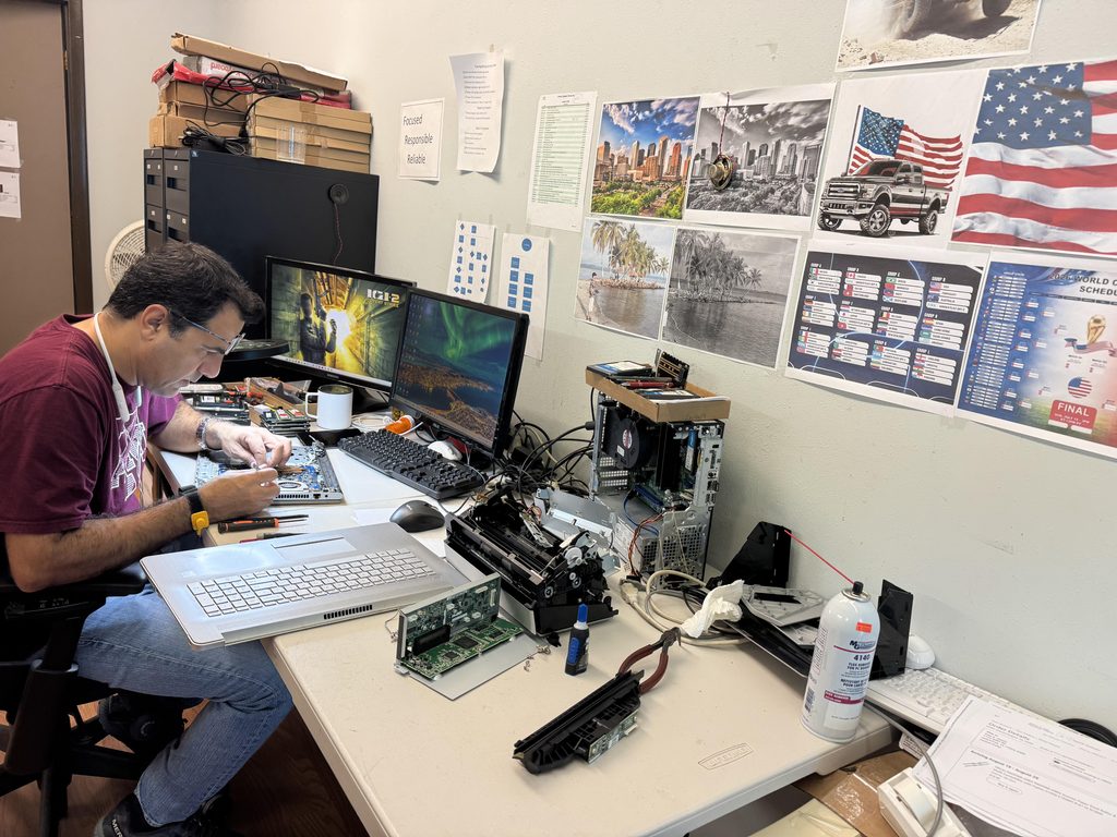 Technician repairing a laptop as part of professional laptop repair and IT support services in Houston.